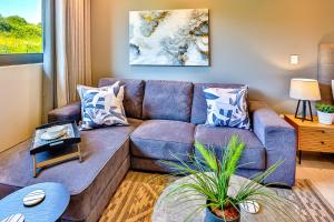 un salon avec un canapé bleu avec des oreillers dans l'établissement Tranquility meets serenity, à Ballito