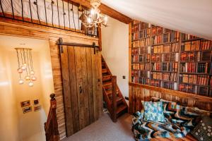a room with a staircase and bookshelves at ThePiggery No 14 in Haxey