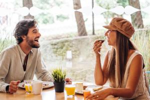 a man and woman sitting at a table eating food at Stay Hotel Porto Centro Trindade in Porto