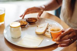 a plate of breakfast food with toast and coffee on a table at Stay Hotel Porto Centro Trindade in Porto