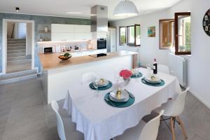 a kitchen and dining room with a table and chairs at Apartman Kalinda in Rijeka