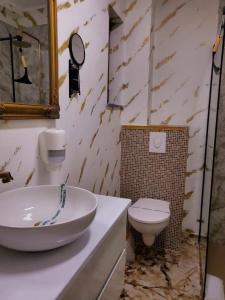 a bathroom with a sink and a toilet at Lemon Breeze in Constanţa