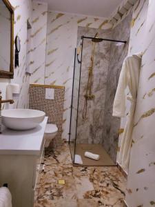 a bathroom with a shower and a toilet and a sink at Lemon Breeze in Constanţa +8 photos