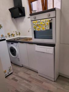 a kitchen with a microwave and a washing machine at Lemon Breeze in Constanţa