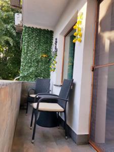 two chairs and a table on a balcony at Lemon Breeze in Constanţa