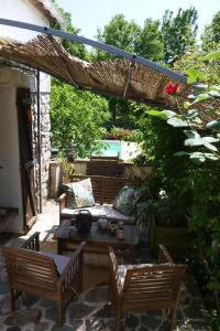 a patio with two chairs and a table at Le Nid du Cormier in Ville-Saint-Jacques