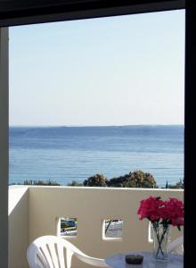 a table with a view of the ocean from a balcony at Vrokastro Apartments in Istro