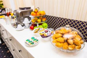 a kitchen counter with a bowl of bread and fruit at Mira Hotel in Moscow