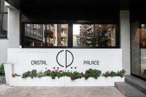 a building with a sign on the side of it at Cristal Palace Hotel in Andria