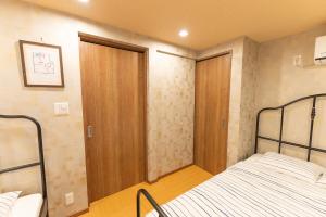 מיטה או מיטות בחדר ב-Guest House Kubo Homes Tengachaya 1