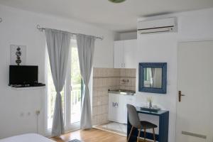 a kitchen with a table and a chair in a room at Vila Marinessa in Hvar