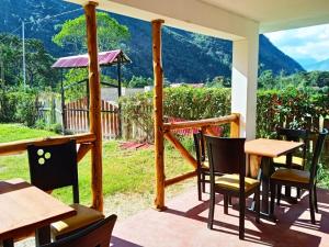 a patio with a table and chairs and a view at Casa Hospedaje el Prado Eco turismo in Oxapampa