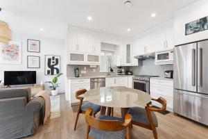 a kitchen and living room with a table and a couch at Charming 3BR Home in a Lovely Vancouver Neighborhood in Vancouver +38 photos