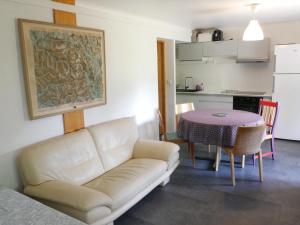 a living room with a couch and a table at Appartement RDC chalet 55m2 in Briançon