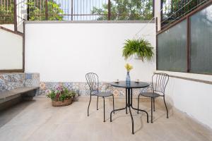 a patio with a table and chairs in a room at Casa Stella in Vico Equense