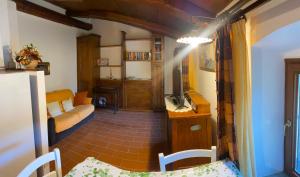 a small living room with a couch and a table at 34- Casa di Chiaretta in Val d'Orcia, Sport e Cultura in Castel del Piano +45 photos