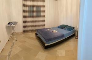 a small bed in a room with a table at Zina Villa in Temlale
