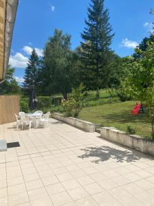 a patio with tables and chairs and a playground at Au calme - Maison avec grand jardin - Proche zoo de Beauval in Vicq-sur-Nahon