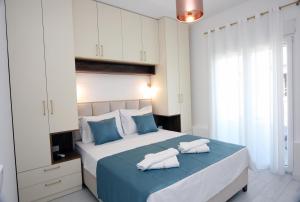 a bedroom with a large bed with towels on it at Venima luxury Seaview Pine Apartment in Tivat