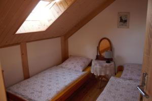 two beds in a small room with a window at Całoroczny domek z patio in Władysławowo