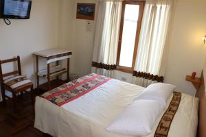 Un pat sau paturi într-o cameră la Picol Hostal