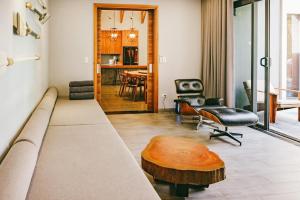 a living room with a couch and a table at Villa Luxury 3 Phòng ngủ Private Pool - Coastar Hồ Tràm in Long Hai +18 photos