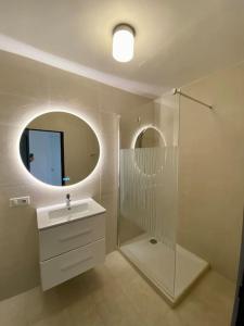 a bathroom with a sink and a shower and a mirror at MarinesAppartement, La terrasse Tropézienne in Saint-Tropez +7 photos