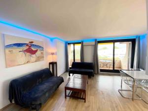 a living room with a couch and a table at MarinesAppartement, La terrasse Tropézienne in Saint-Tropez