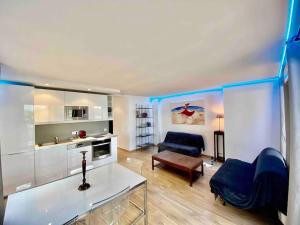 a kitchen and living room with a couch and a table at MarinesAppartement, La terrasse Tropézienne in Saint-Tropez