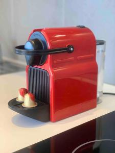 a red toaster sitting on top of a counter at MarinesAppartement, La terrasse Tropézienne in Saint-Tropez