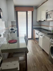 a kitchen with a table and a counter top at La Nala in Villaviciosa