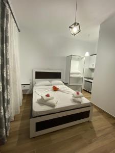 a bedroom with a bed with towels on it at Rentrooms Geni in Ksamil +18 photos