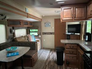 a kitchen and living room of an rv at Winnasquam Beach Resort in Belmont