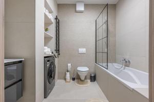 a bathroom with a toilet and a washing machine at 3 Bedroom Condo w Garage and Balcony in Budapest +23 photos