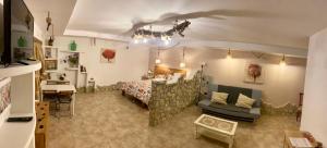 a large room with a bed and a couch at Casa rural la grulla in Montmesa