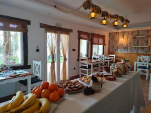 a table with bananas and other fruits on it at Casa rural la grulla in Montmesa