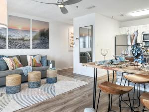 a living room with a couch and a table at Sunrise Destin-ation Beach view Heated Pool in Destin