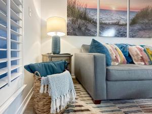 a living room with a couch and a lamp at Sunrise Destin-ation Beach view Heated Pool in Destin