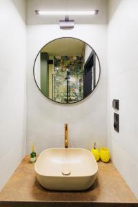 a bathroom with a sink and a mirror at Jungle Apartment chill&bed Zator in Zator