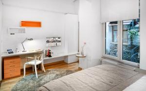 a bedroom with a bed and a desk and a window at Nuru Ziya Residences in Istanbul