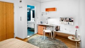a bedroom with a bed and a desk and a table at Nuru Ziya Residences in Istanbul