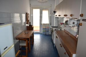 a kitchen with a sink and a table in it at Vacanze Romane in Rome