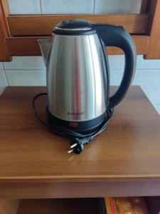 a tea kettle sitting on top of a table at Vacanze Romane in Rome