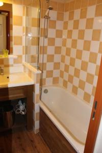 a bathroom with a bath tub and a sink at appartement 5 places à VARS in Vars
