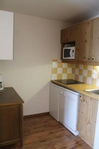 a kitchen with a counter top and a microwave at appartement 5 places à VARS in Vars