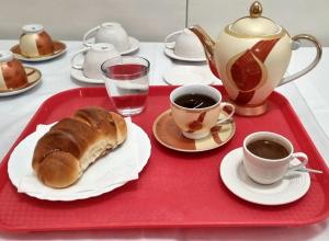 a tray with a plate of bread and two cups of coffee at Vila AMA Kruje in Krujë