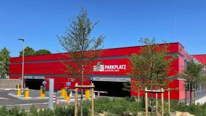 a red building with a happy exit sign on it at Wohnlich in Würselen