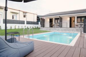 a swimming pool on a deck next to a house at EliGio Luxury Suites in Asprovalta