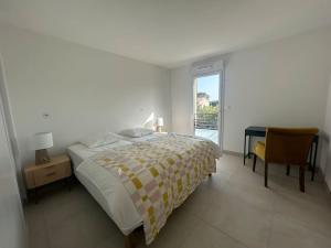 a bedroom with a bed and a desk and a window at Clos d'Alice Villa 3 in Sainte-Maxime +9 photos