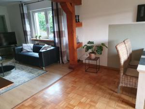 a living room with a couch and a table at Wegeners Ferienwohnung in Brilon